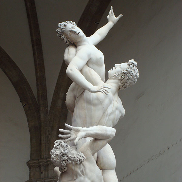 A marble statue of three human figures