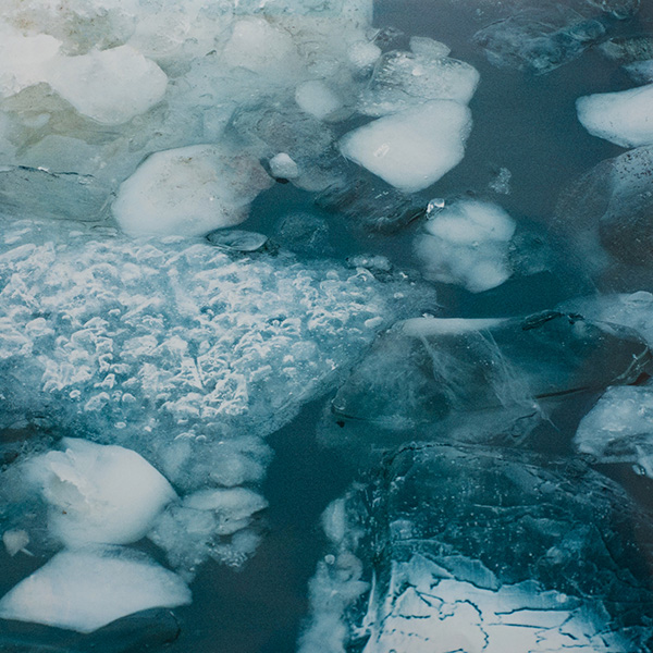 Close-up photo of slabs of ice sit on top of the river.