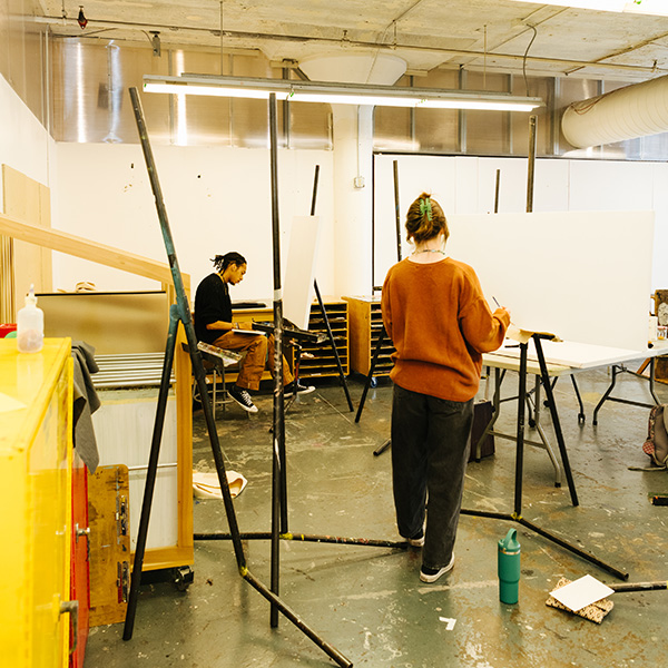 A student paints in a MIAD classroom